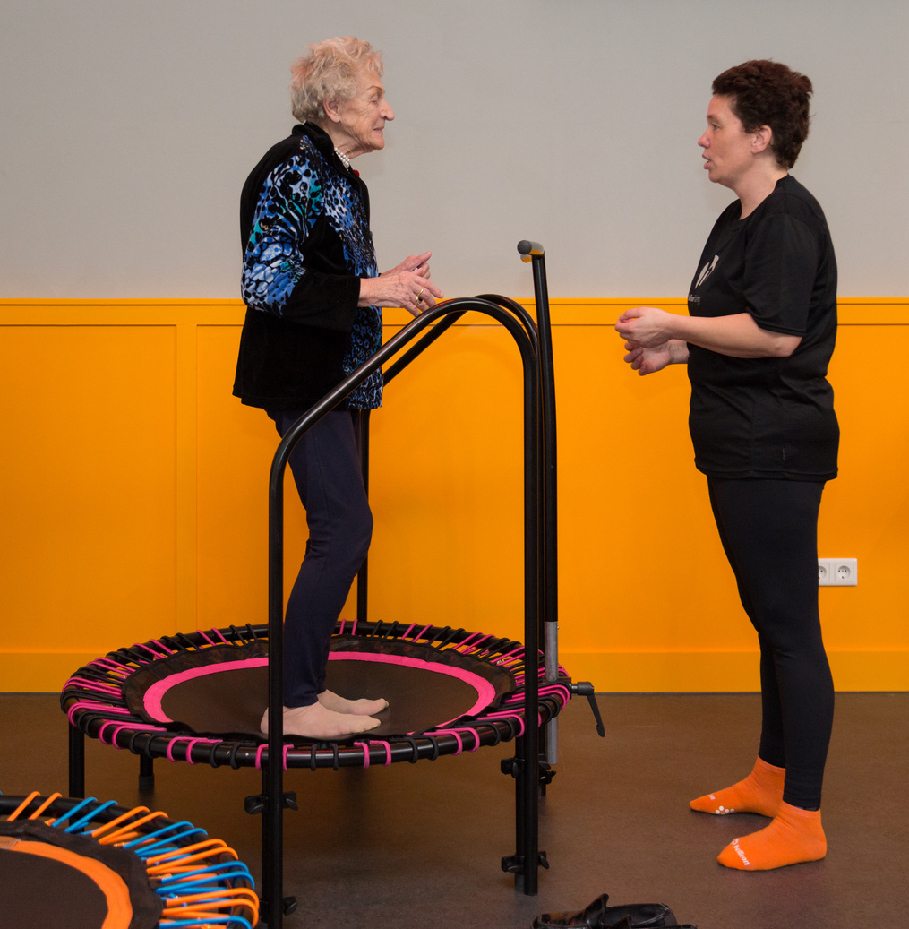 Woman in Black Shirt and Pants Standing on Black and Red Round Trampoline